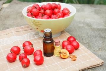 hawthorn seed oil container on napkin on wooden background