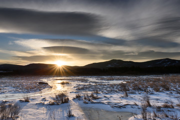 Dramatic Sky at Sunrise over Frozen Landscape