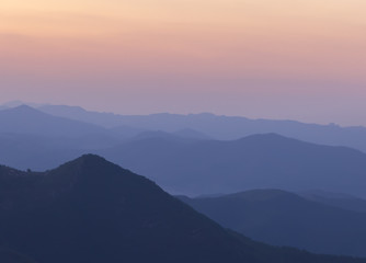 Silhouettes of the mountain hills after sunset. mountain cascade