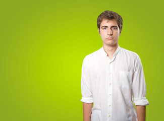 Sad young man on green background