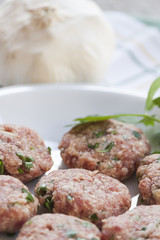 Dish of meatballs with garlic and parsley