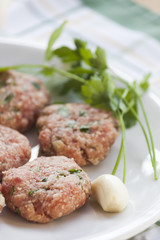 Dish of meatballs with garlic and parsley