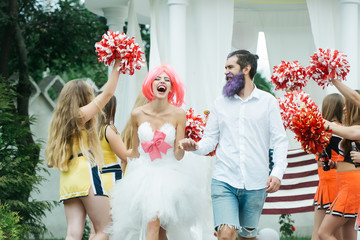 wedding couple with cheerleaders