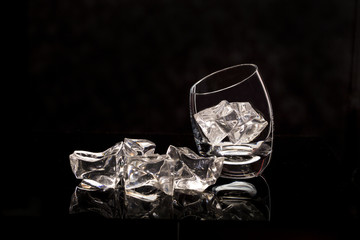 two glasses1 with ice / glasses for vodka with ice on a black background.