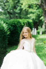 Fototapeta premium small girl in white dress outdoor
