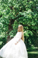 Obraz na płótnie Canvas small girl in white dress outdoor