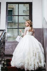 Fototapeta na wymiar small girl in white dress near big window