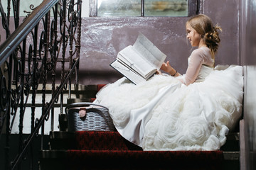 small girl near window with basket and book © Volodymyr