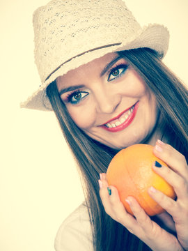 Woman holding grapefruit citrus fruit in hand