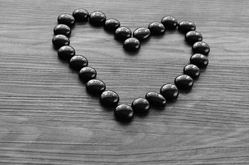 Heart make out of black pebbles