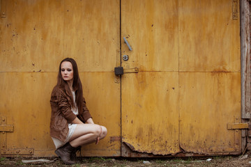 Portrait of Fashion Model Girl on the Industrial Background.