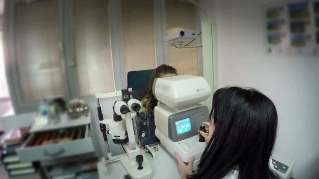 Young girl having her eyes examined by an eye doctor