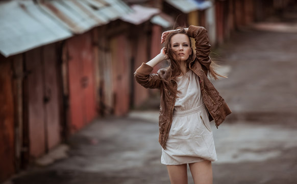 Portrait of Fashion Model Girl on the Industrial Background.