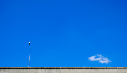 Highway with electric pole and blue sky
