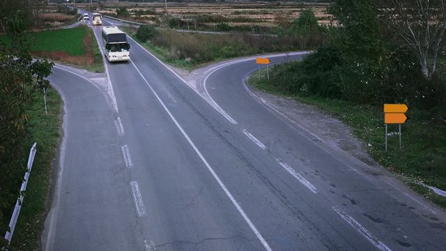 Busses on road at dusk. Aerial 