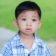 The boy standing eyes staring ahead.