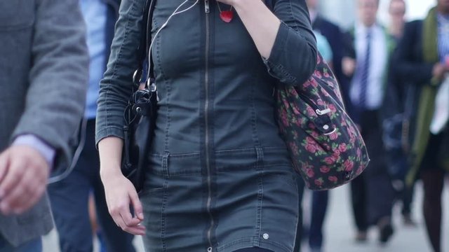 People using phone headphones in London