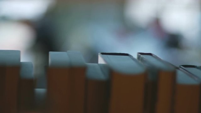 Rows of books in library slow motion