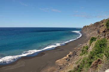 Fishing boats under cliff
