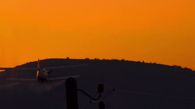 spray plane crop duster silhouette at sunset