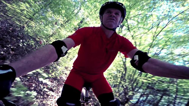 MTB Mountain bike downhill racer riding fast in the forrest,  steadicam footage
