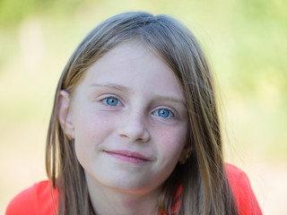 Fototapeta premium Beautiful young girl outdoors, portrait children close up