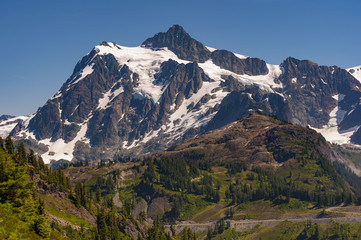 Mt. Shuksan, Washington.  Mount Shuksan may be one of the most photographed mountains in the Cascade Range seen here on the Chain Lakes Loop Trail. Mt. Baker National Forest.