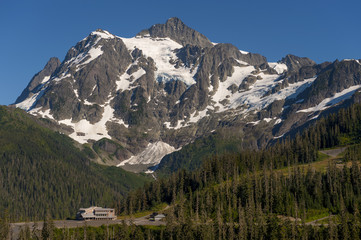 Mt. Baker Ski Area. White Salmon Lodge is dwarfed by Mt. Shuksan during a glorious summer day in the Mt. Baker Recreation area, Washington State.