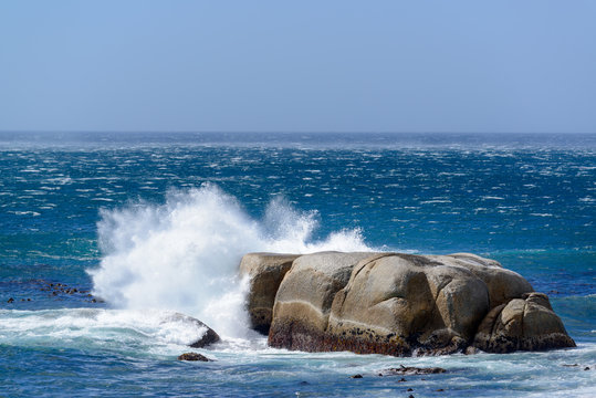 Wave crashing into rock at sea during a storm. Cape Town. Western Cape. South Africa