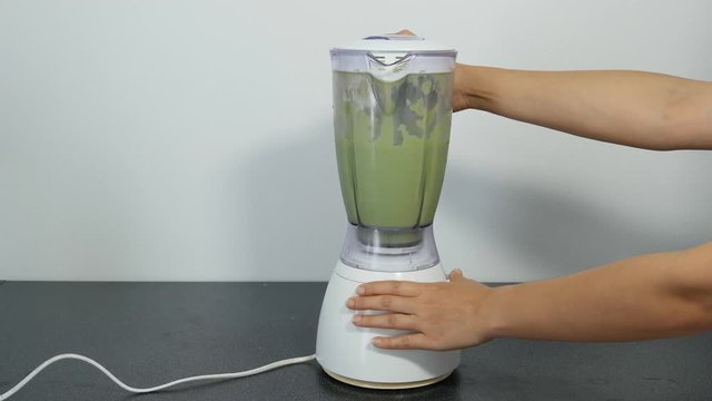 4k of Chef pouring water to the Blender for making green tea