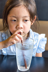 Asian Child Drinking Water from Glass