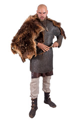 Medieval viking in chain mail and a bearskin rug. Isolated on white