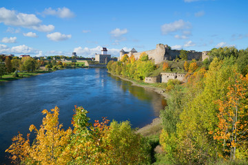 Fototapeta na wymiar Sunny september day on the border river Narva. Look at the Russian Ivangorod fortress and the Estonian Hermann castle