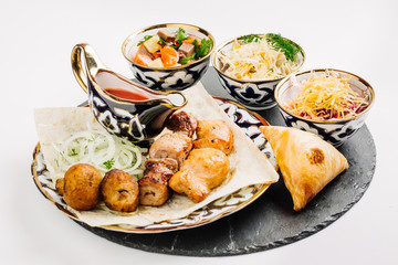 Healthy barbecue different meat with vegetables and sauce.