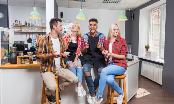 People friends drinking coffee shop talking laughing with barista sitting at bar counter
