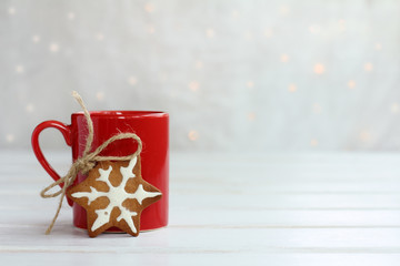 delicious Christmas morning/ Festive gingerbread with red cup on the background lights 
