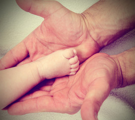 daddys hands and babys foot
