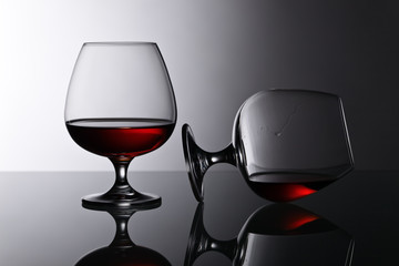 Two snifters of brandy on glass table