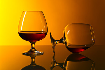Two snifters of brandy on glass table