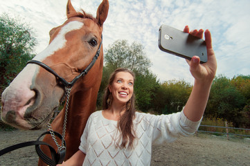 Funny selfie with my friend! Attractive smiling young woman holding smartphone and making selfie...
