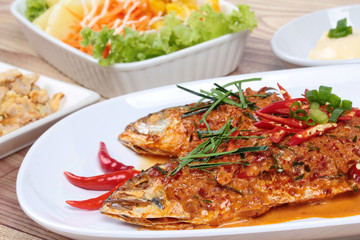 Mackerel fish fried topped spicy curry with side dish. Selective focus.
