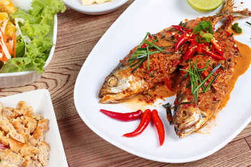 Mackerel fish fried topped spicy curry with side dish. Selective focus.