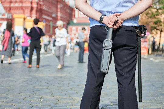 City Safety. Policeman In The Street With Metal Detector Wand