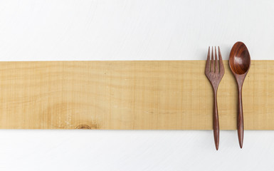Wooden fork and spoon on wooden sign