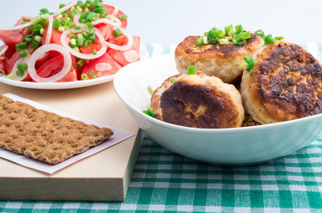 Homemade fried meatballs in a white bowl closeup