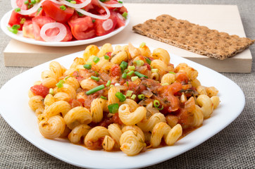 Cooked pasta cavatappi with stewed vegetables sauce