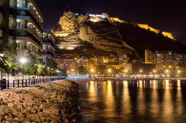 Fototapeta premium Cosy evening harbor in Alicante surrounded by houses and mountains, Spain
