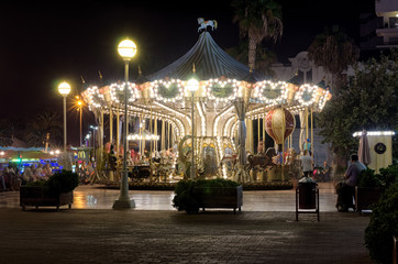 Amazing carousel with many lights on the quay in Alicante, Spain
