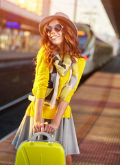 Pretty young woman at a train station (autumn toned image)