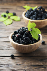 Sweet wild blackberry on the wooden table